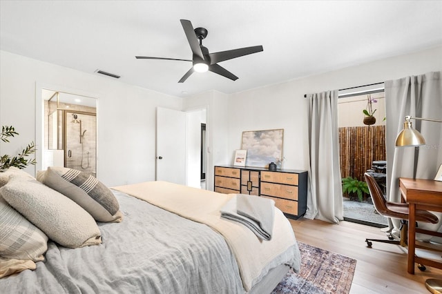 bedroom featuring ceiling fan, light hardwood / wood-style floors, and ensuite bath