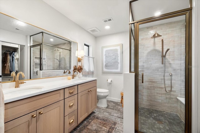 bathroom with vanity, toilet, and walk in shower