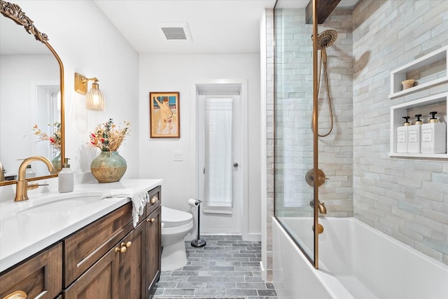 full bathroom with vanity, tiled shower / bath combo, and toilet