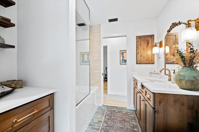 bathroom with vanity and combined bath / shower with glass door