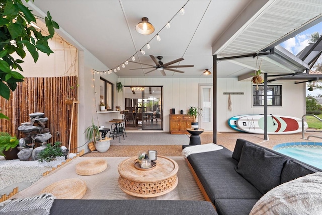 living room featuring lofted ceiling with skylight, carpet flooring, and ceiling fan