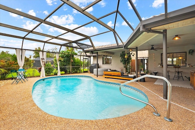 view of pool with ceiling fan, a patio, and glass enclosure