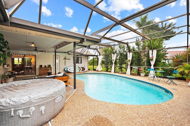 view of pool with a lanai, a patio area, and ceiling fan