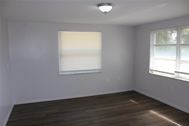 empty room featuring dark wood-type flooring