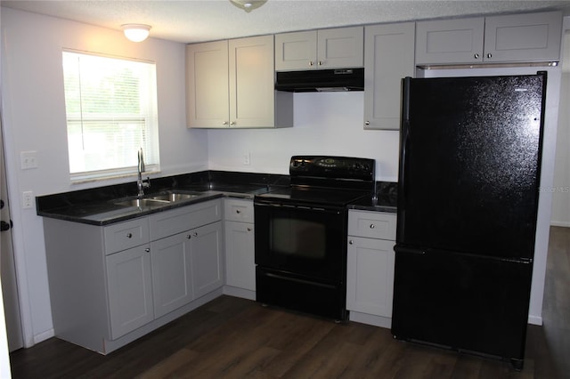 kitchen featuring white cabinets, black appliances, dark hardwood / wood-style flooring, and sink