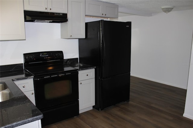 kitchen featuring dark wood-type flooring, dark stone counters, black appliances, and white cabinets