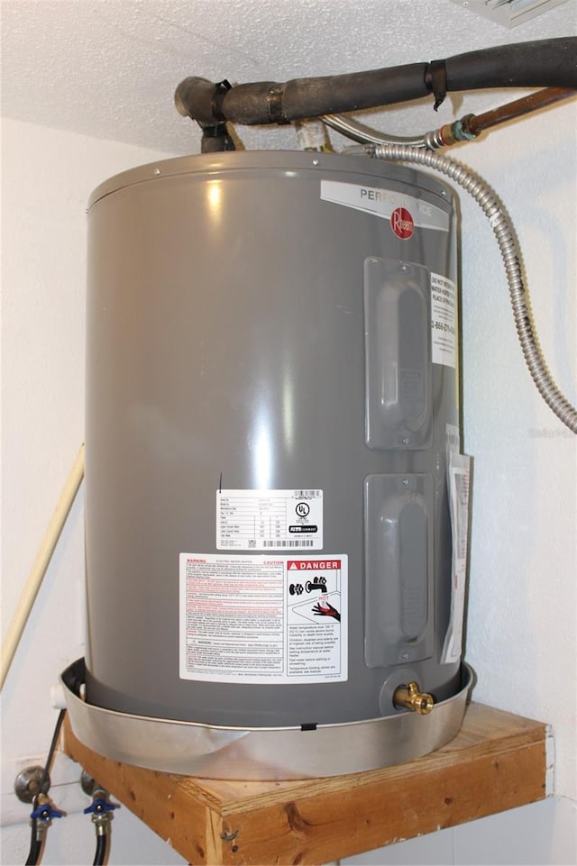 utility room featuring electric water heater