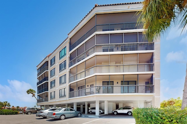 view of property featuring uncovered parking