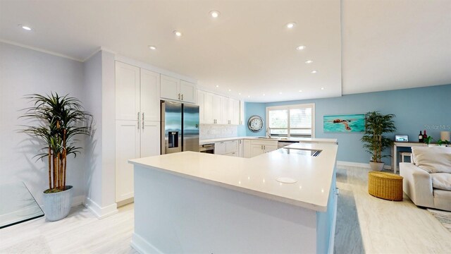 kitchen with white cabinetry, light hardwood / wood-style floors, tasteful backsplash, stainless steel fridge with ice dispenser, and kitchen peninsula