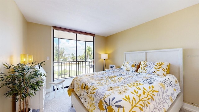 bedroom featuring access to outside, expansive windows, baseboards, and carpet flooring