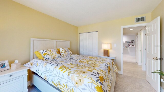 carpeted bedroom with a closet