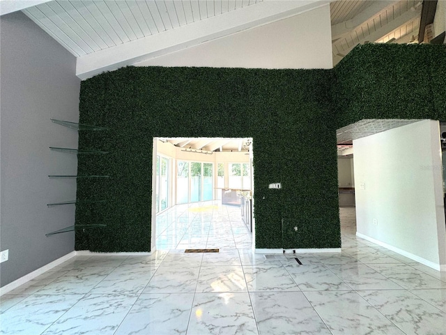 unfurnished room featuring light tile patterned floors and vaulted ceiling