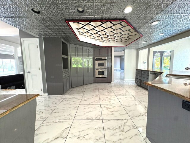 kitchen featuring appliances with stainless steel finishes, sink, and light tile patterned floors