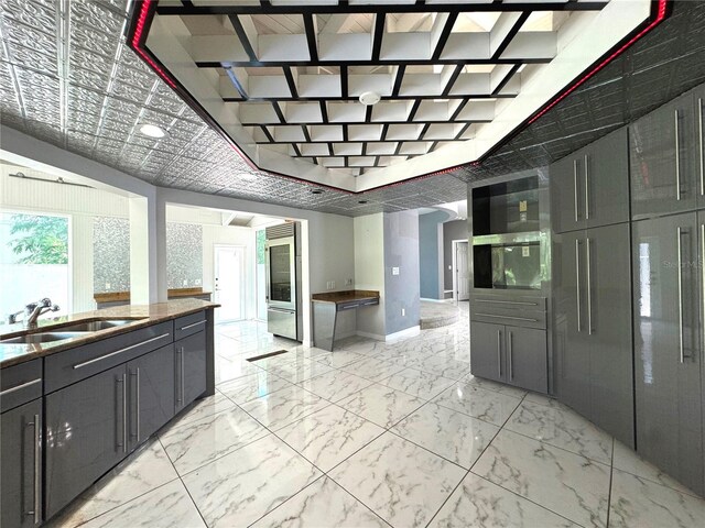 kitchen featuring light tile patterned flooring and sink