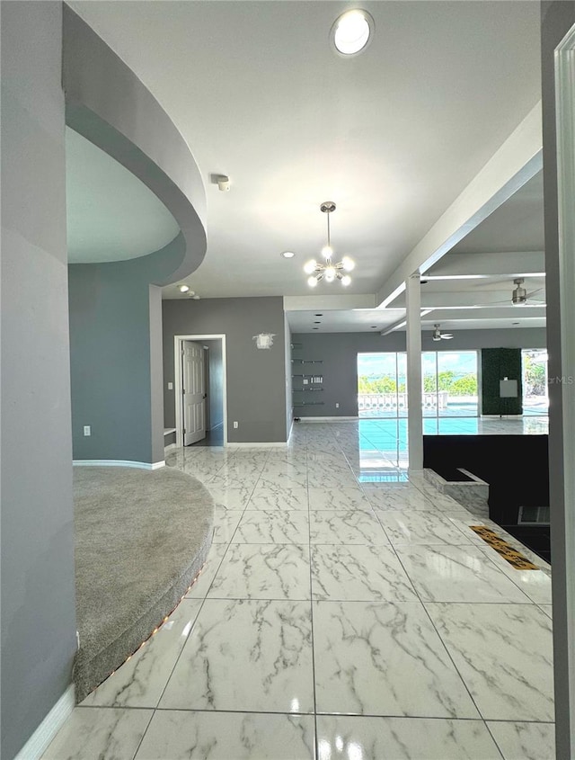 interior space featuring ceiling fan with notable chandelier