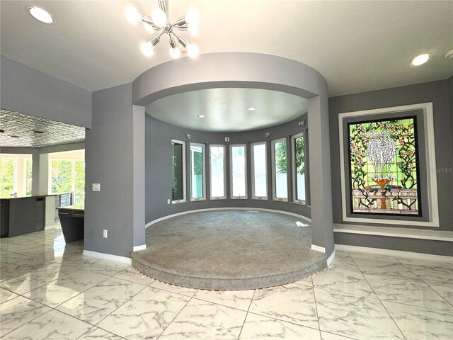 tiled foyer with a notable chandelier