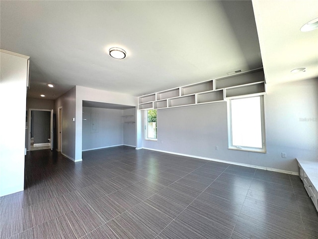 empty room with dark tile patterned floors