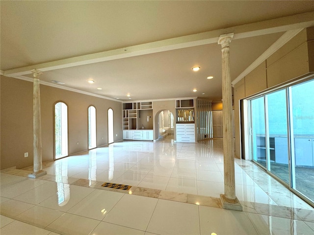 interior space featuring decorative columns, light tile patterned floors, and a healthy amount of sunlight