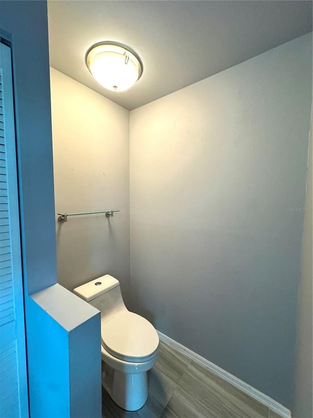 bathroom with tile patterned flooring and toilet