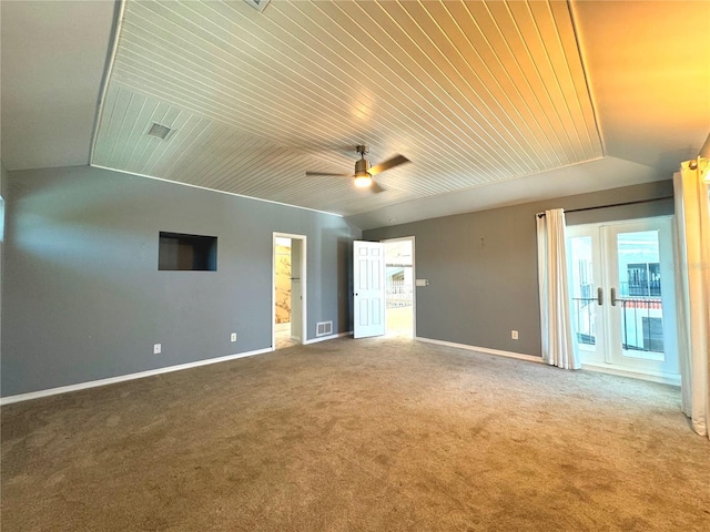 spare room with ceiling fan, carpet floors, and wood ceiling