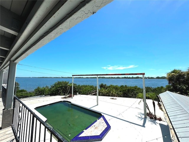 exterior space with a patio and a water view