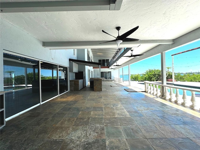 view of patio / terrace featuring ceiling fan and a swimming pool