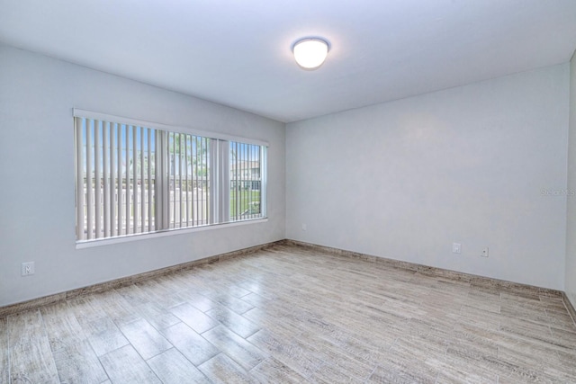 spare room with light hardwood / wood-style floors