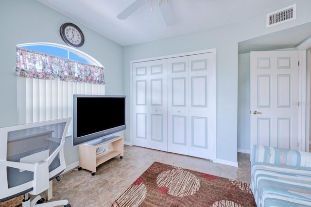 tiled living room with ceiling fan