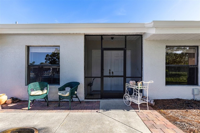 doorway to property featuring a patio area