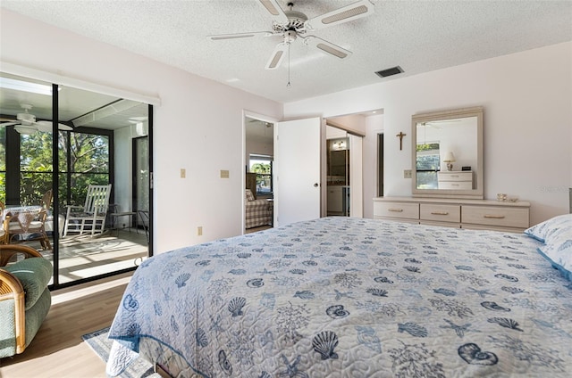 bedroom with ceiling fan, a textured ceiling, access to outside, and dark wood-type flooring