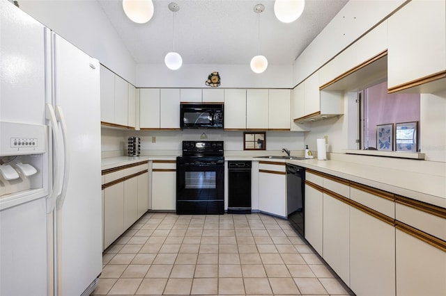 kitchen with decorative light fixtures, light tile patterned floors, black appliances, and white cabinetry