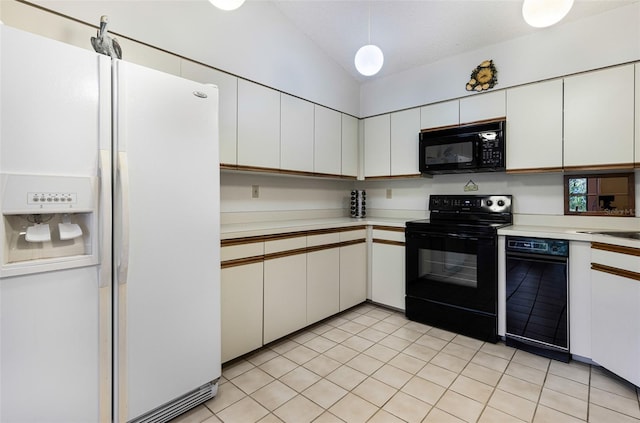 kitchen with light tile patterned flooring, white cabinets, vaulted ceiling, and black appliances