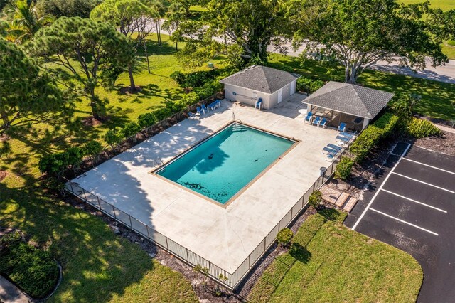 view of pool with a patio and a yard