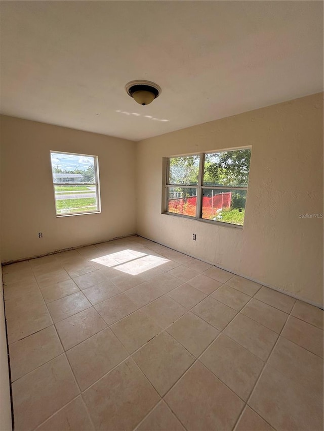 empty room with light tile patterned floors