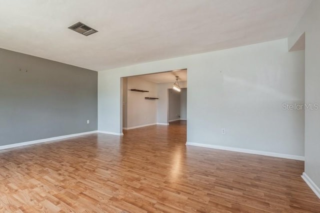 spare room featuring wood-type flooring