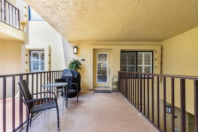 view of exterior entry with a balcony