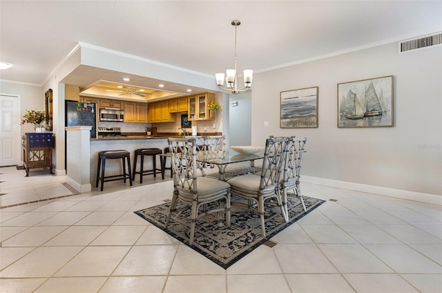 dining space with a raised ceiling, light tile patterned flooring, ornamental molding, and an inviting chandelier