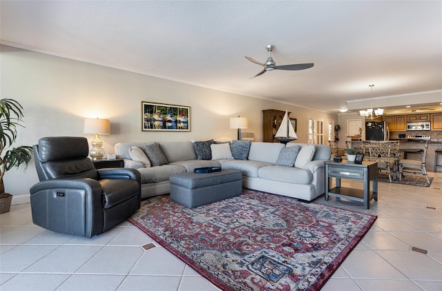 living room featuring light tile patterned flooring, ceiling fan with notable chandelier, and crown molding