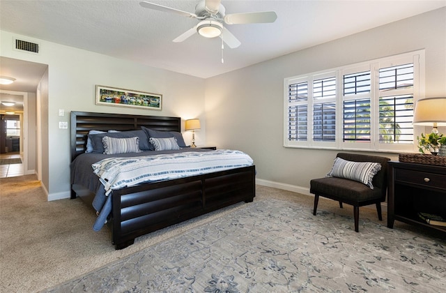 bedroom featuring light colored carpet and ceiling fan