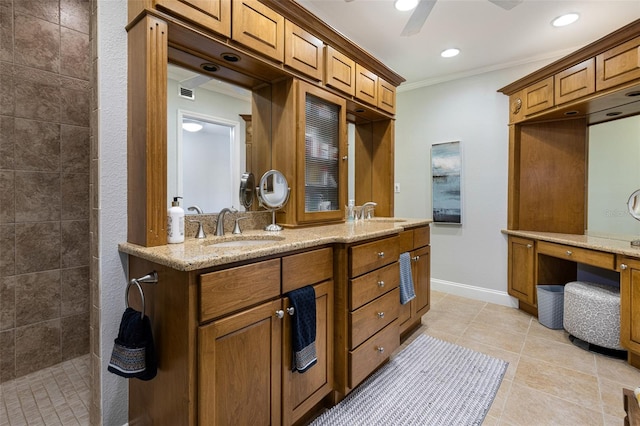 bathroom featuring tiled shower, tile patterned floors, crown molding, vanity, and ceiling fan