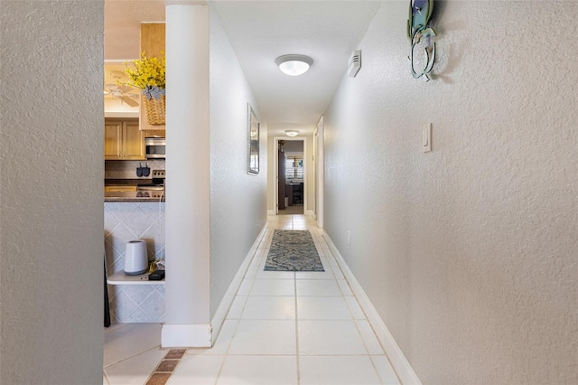 hallway featuring light tile patterned floors