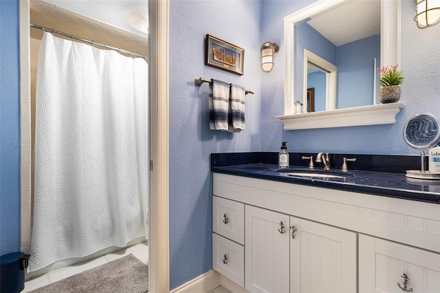 bathroom with walk in shower and vanity