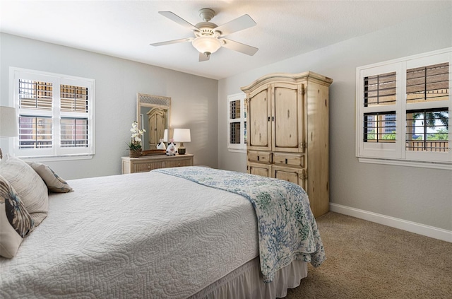 carpeted bedroom with ceiling fan and multiple windows