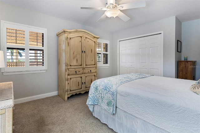 bedroom featuring light carpet, a closet, and ceiling fan