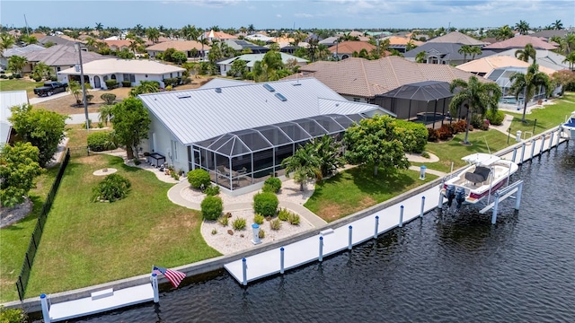 drone / aerial view featuring a residential view and a water view