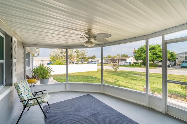 unfurnished sunroom featuring ceiling fan