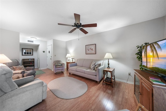 living room with ceiling fan and wood-type flooring