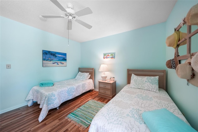 bedroom with ceiling fan and dark wood-type flooring