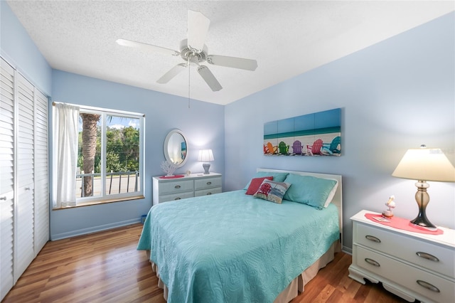 bedroom with a textured ceiling, light wood-type flooring, a closet, and ceiling fan