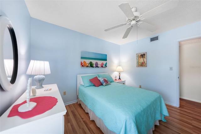 bedroom with ceiling fan and wood-type flooring